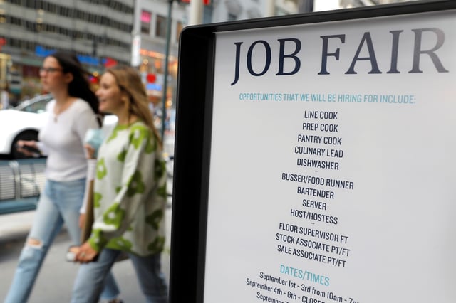 Signage for a job fair is seen on 5th Avenue after the release of the jobs report in Manhattan, New York City, U.S., September 3, 2021. REUTERS/Andrew Kelly/File photo