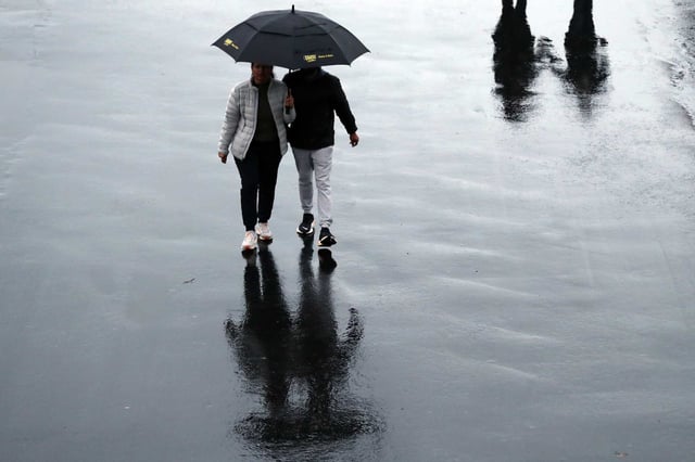 A couple walks under an umbrella at Pier 39 in San Francisco. A new study published in the Journal of the American Heart Association finds that men are more than twice as likely as women to die from takotsubo cardiomyopathy, also known as broken heart syndrome. 
