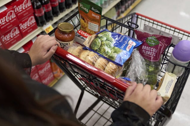 A shopper who depends on California&#39;s SNAP benefits to help pay for food, shops for groceries at a supermarket in Bellflower, Calif., on Monday, Feb. 13, 2023. 
