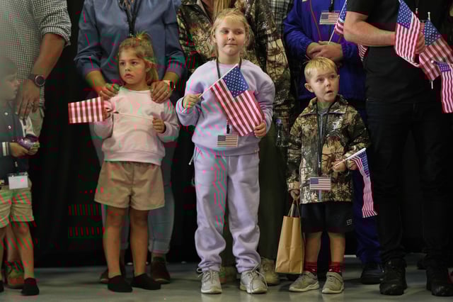 Young Afrikaner refugees from South Africa holding American flags arrive, Monday, May 12, 2025, at Dulles International Airport in Dulles, Va. (AP Photo/Julia Demaree Nikhinson)
