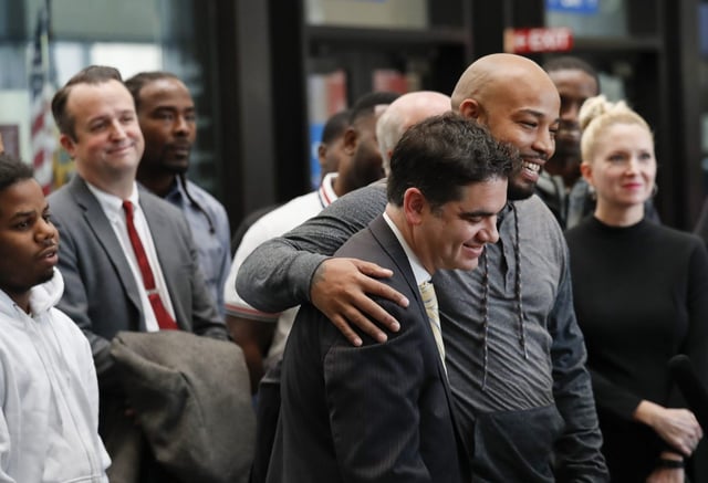 Joshua Tepfer, center, with the Exoneration Project, is hugged by Leonard Gipson as they speak  at a press conference at the Leighton Criminal Court Building in Chicago on Nov. 16, 2017. The Exoneration Project filed a Consolidated Petition requesting the exoneration of 15 men who insisted they were framed by disgraced Sgt. Ronald Watts. (José M. Osorio/Chicago Tribune)