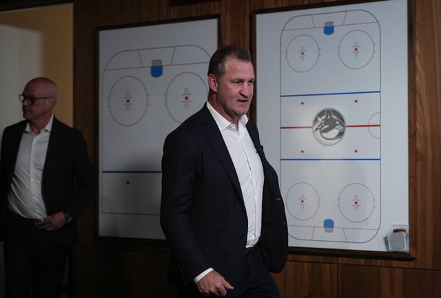 Vancouver Canucks new head coach Adam Foote and general manager Patrik Allvin, back left, arrive for a news conference after Foote was promoted from assistant coach by the NHL hockey team, in Vancouver on Thursday, May 15, 2025. THE CANADIAN PRESS/Darryl Dyck