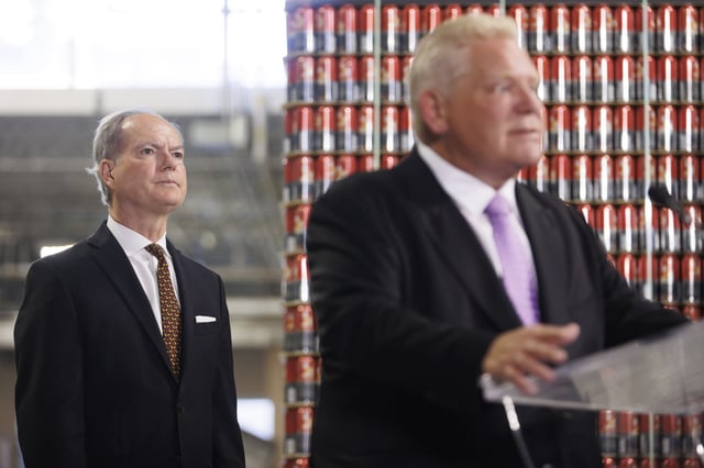 Ontario Finance Minister Peter Bethlenfalvy watches as Ontario Premier Doug Ford speaks to media at a press conference at the Cool Beer Brewing Company in Toronto, on Wednesday, July 10, 2024. 
