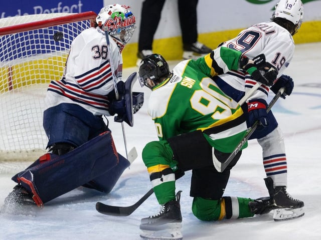 Landon Sim of the London Knights is checked by Luca Marrelli of the Oshawa Generals as Oliver Bonk scores on Generals goalie Jacob Oster during Game 2 of the Ontario Hockey League final at Canada Life Place in London on May 10, 2025.  (Mike Hensen/The London Free Press)