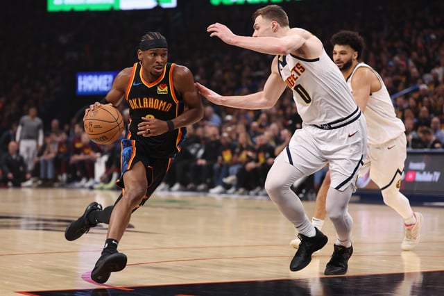 Shai Gilgeous-Alexander #2 of the Oklahoma City Thunder is defended by Christian Braun #0 of the Denver Nuggets during the first half of Round Two Game One of the 2025 NBA Playoffs at Paycom Center on May 05, 2025 in Oklahoma City, Oklahoma.