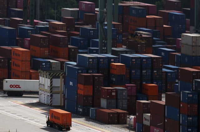 Containers are stacked at Brani container terminal in Singapore February 20, 2025. REUTERS/Edgar Su
