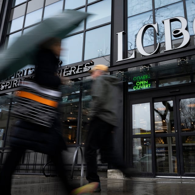 People walk by an LCBO in Toronto, on Tuesday, March 4 2025. THE CANADIAN PRESS/Arlyn McAdorey