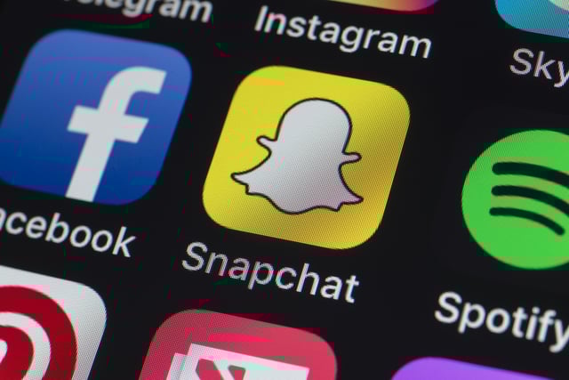London, UK - July 19, 2018: The buttons of Instagram, Skype, Pinterest, Spotify, Snapchat Facebook and other apps on the screen of an iPhone.