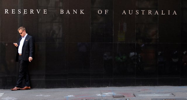 A man smokes next to the Reserve Bank of Australia headquarters in central Sydney, Australia February 6, 2018. REUTERS/Daniel Munoz/File Photo