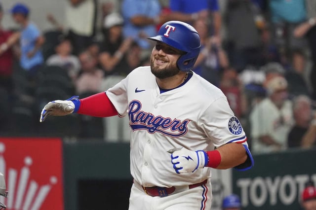 Texas Rangers Jake Burger smiles after hitting a home run during the sixth inning of a baseball game against the Houston Astros, Thursday, May 15, 2025, in Arlington, Texas. (AP Photo/LM Otero)