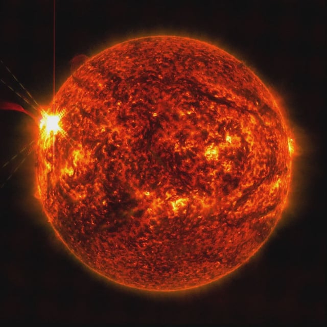 NASA’s Solar Dynamics Observatory captured this image of a solar flare — seen as the bright flash on the left – on May 14. The image shows a subset of extreme ultraviolet light that highlights the extremely hot material in flares and which is colorized in red. NASA/SDO