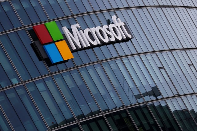 A view shows a Microsoft logo at Microsoft offices in Issy-les-Moulineaux near Paris, France, March 21, 2025. REUTERS/Gonzalo Fuentes/File Photo