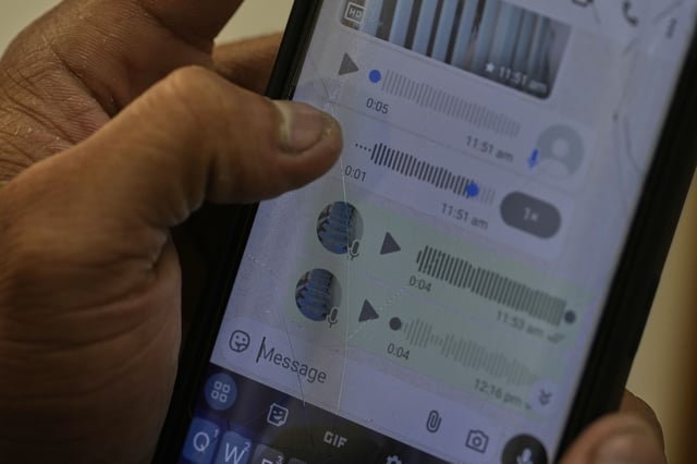 A Rohingya refugee who has not been identified due to safety concerns, shows his conversation details on WhatsApp with his family members in Myanmar as he talks to The Associated Press in New Delhi, India, Friday, May 16, 2025. (AP Photo/Manish Swarup)
