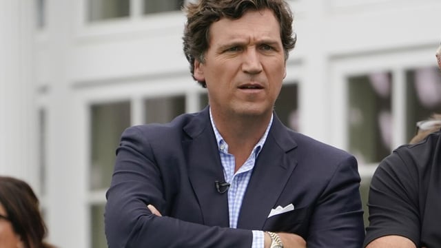 FILE - Tucker Carlson attends the final round of the Bedminster Invitational LIV Golf tournament in Bedminster, N.J., Sunday, July 31, 2022. Fox News says it has agreed to part ways with Tucker Carlson, less than a week after settling a lawsuit over the network’s 2020 election reporting. The network said in a press release Monday that the popular and controversial prime-time host's last program aired on Friday. (AP Photo/Seth Wenig, File)