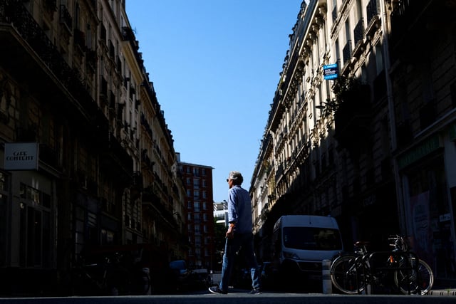 A man walks on Rue Pache street, near the location where a masked gang attempted to kidnap the daughter of a crypto businessman, in Paris, France, May 14, 2025. REUTERS/Gonzalo Fuentes/File Photo