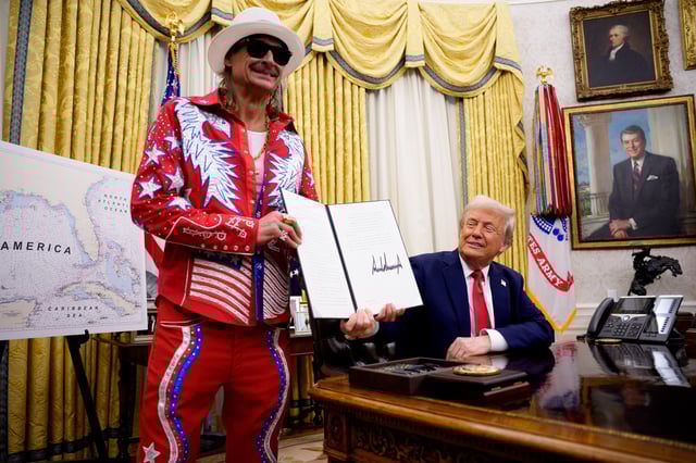 President Donald Trump with Kid Rock, signs an executive order in the Oval Office of the White House on March 31, 2025 in Washington, DC.