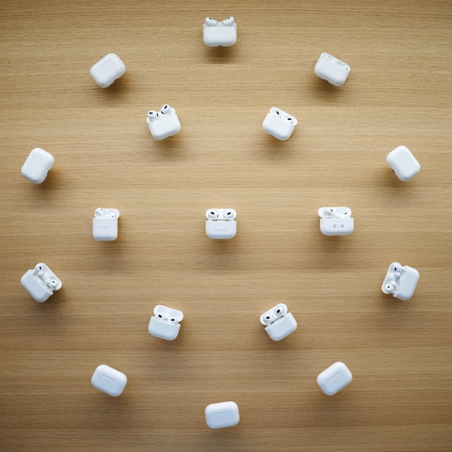 open airpod cases arranged in a cirlce