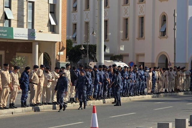 Libyan security forces line the streets as protesters gather in the capital's Martyrs' Square after days of deadly clashes to call for the resignation of the Tripoli government.