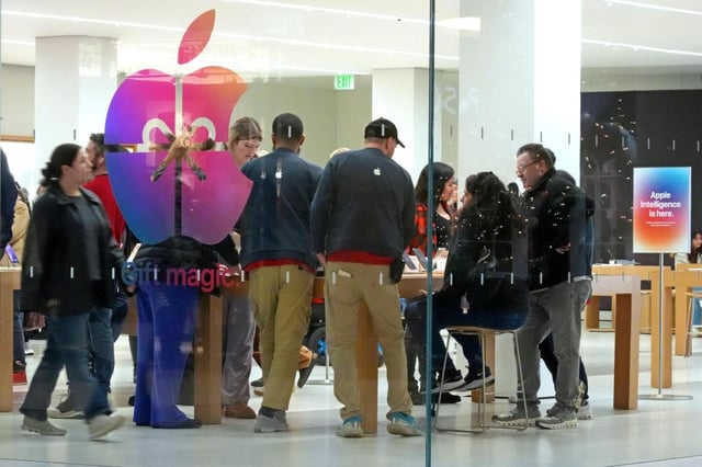 FILE – Shoppers look at Apple products in the Apple Store at the Walden Galleria in Buffalo, NY, on Saturday, Nov. 30, 2024. (AP Photo/Gene J. Puskar, File)