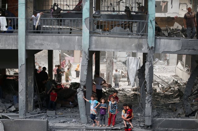 Palestinians inspect the damage at a school sheltering displaced people, following an Israeli strike, in Jabalia refugee camp, in the northern Gaza Strip, May 12, 2025. REUTERS/Mahmoud Issa/File Photo
