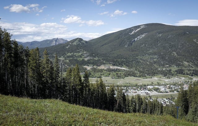 Grassy Mountain, peak to left, and the Grassy Mountain Coal Project are seen north of Blairmore, Alta., Thursday, June 6, 2024. 