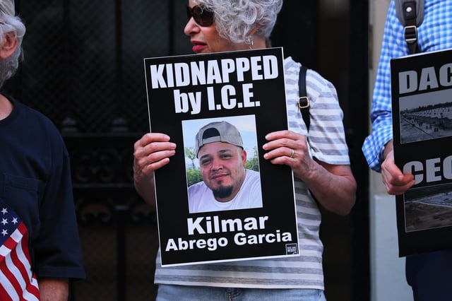 A protester can be seen holding a photo of Kilmar Abrego Garcia as demonstrators gather to protest against the deportation of immigrants to El Salvador outside the Permanent Mission of El Salvador to the United Nations on April 24, 2025, in New York City. (Photo by Michael M. Santiago/Getty Images)