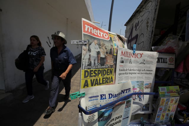 People walk past a newsstand displaying front pages covering the funeral Mass of Valeria Marquez, 23, a Mexican social media influencer who was fatally shot during a TikTok livestream, in Guadalajara, Mexico, May 16, 2025. REUTERS/Stringer