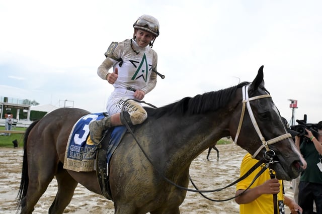 Jockey Flavien Prat rides Margie&#39;s Intention into the winners circle after winning the Black-Eyed Susan Stakes at Pimlico Race Course. (Kim Hairston/Staff)