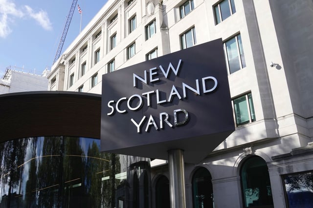 A sign stands in front of the New Scotland Yard, the headquarters of the London Metropolitan Police, in 2023.