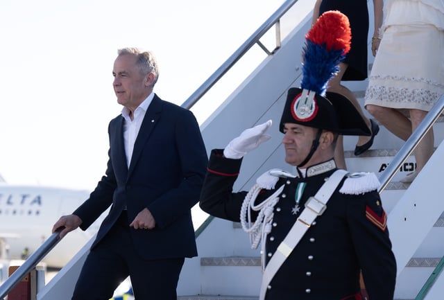 Prime Minister Mark Carney disembarks a government plane, Saturday, May 17, 2025 in Rome, Italy.  THE CANADIAN PRESS/Adrian Wyld