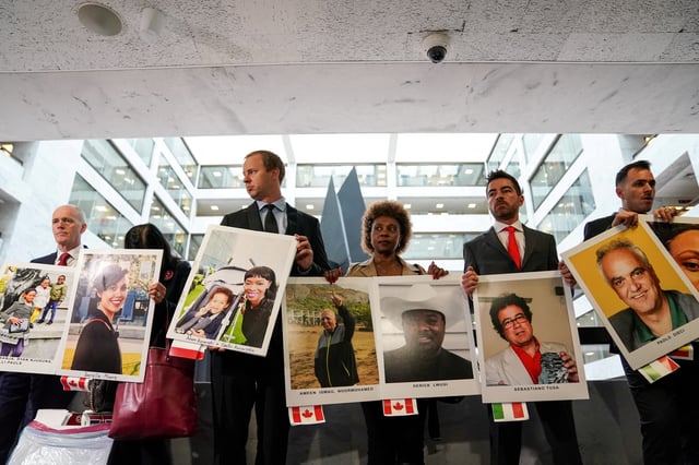 Family members hold photographs of Boeing 737 MAX crash victims lost in two deadly 737 MAX crashes that killed 346 people as they arrive for Boeing CEO Dennis Muilenburg's testimony before a Senate Commerce, Science and Transportation Committee hearing on “aviation safety” and the grounded 737 MAX on Capitol Hill in Washington, U.S., October 29, 2019.  REUTERS/Sarah Silbiger/File Photo