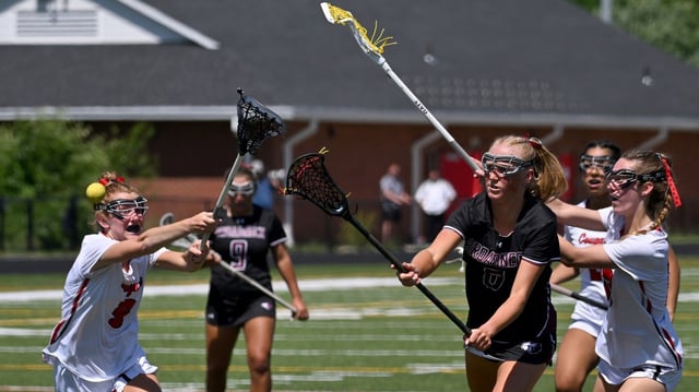 Broadneck’s Raleigh Kerst scores on a free position as Quince Orchard’s Ellie Hodge, left, and Bridget Vandegrift, right, try to stop her in the second quarter. The Broadneck Bruins defeated the Quince Orchard Cougars, 19-14, to win an MPSSAA Class 4A girls lacrosse State Semifinal game at Glen Burnie High School. (Paul W. Gillespie/Staff)
