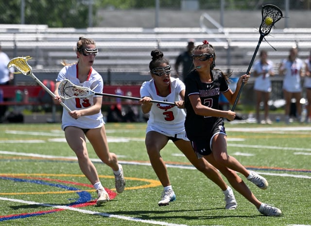 Broadneck’s Sienna Miller runs past Quince Orchard’s Bridget Vandegrift, left, and Amber-Clark Matta, center, in the first quarter. The Broadneck Bruins defeated the Quince Orchard Cougars, 19-14, to win an MPSSAA Class 4A girls lacrosse State Semifinal game at Glen Burnie High School. (Paul W. Gillespie/Staff)
