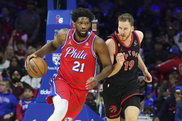 Joel Embiid #21 of the Philadelphia 76ers dribbles the ball against Jakob Poeltl #19 of the Toronto Raptors at the Wells Fargo Center on March 31, 2023 in Philadelphia, Pennsylvania.