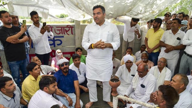Water minister Parvesh Verma interacts with farmers at Daulatpur village in New Delhi on Saturday. (PTI)