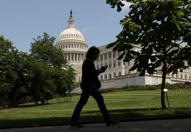 A person walks the grounds of the Capitol on the day President Donald Trump's sweeping tax bill failed to clear a key procedural hurdle in Congress, in Washington, D.C., U.S., May 16, 2025.