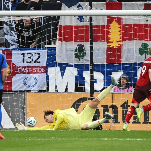 Toronto FC's Ola Brynhildsen (9) scores against CF Montreal goalkeeper Sebastian Breza during first half MLS soccer action in Montreal, Saturday, May 17, 2025. THE CANADIAN PRESS/Graham Hughes