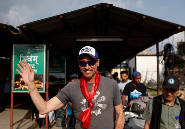 British climber Kenton Cool, 49, waves towards the media personnel, upon his arrival at the airport, as he returns after completing his 17th ascent of Mount Everest, which is the most by any foreign climber, in Kathmandu, Nepal May 19, 2023. REUTERS/Navesh Chitrakar/File Photo