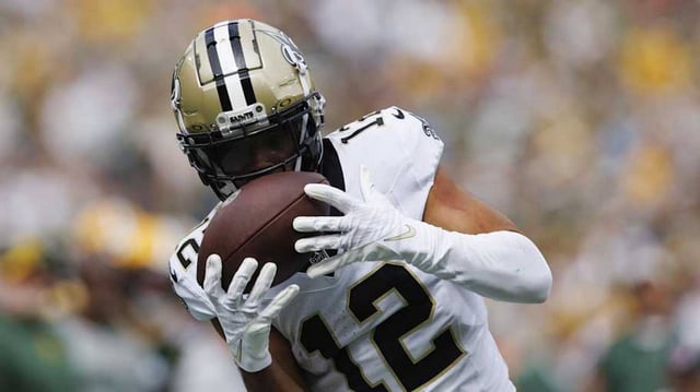 Sep 24, 2023; Green Bay, Wisconsin, USA;  New Orleans Saints wide receiver Chris Olave (12) catches a pass during the second quarter against the Green Bay Packers at Lambeau Field. Mandatory Credit: Jeff Hanisch-Imagn Images