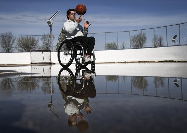 Humboldt Broncos bus crash survivor Ryan Straschnitzki tosses a basketball in Airdrie, Alta., Wednesday, May 14, 2025. THE CANADIAN PRESS/Jeff McIntosh