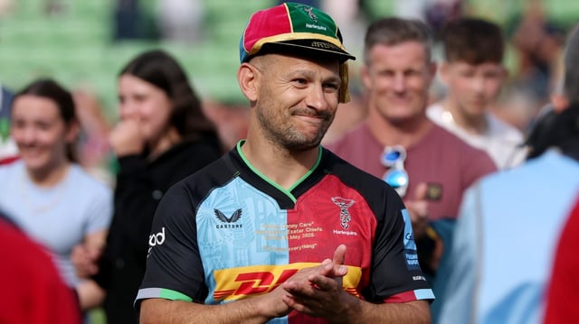 Care applauds the Harlequins fans after being presented with a cap to commemorate his final match at The Stoop
