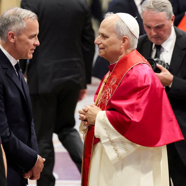 Prime Minister of Canada Mark Carney greets Pope Leo XIV in St. Peter's Basilica, following his inaugural Mass, at the Vatican, May 18, 2025. REUTERS/Claudia Greco