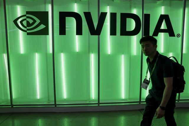 A person walks pass a Nvidia logo at Computex in Taipei, Taiwan June 5, 2024. REUTERS/Ann Wang/File Photo