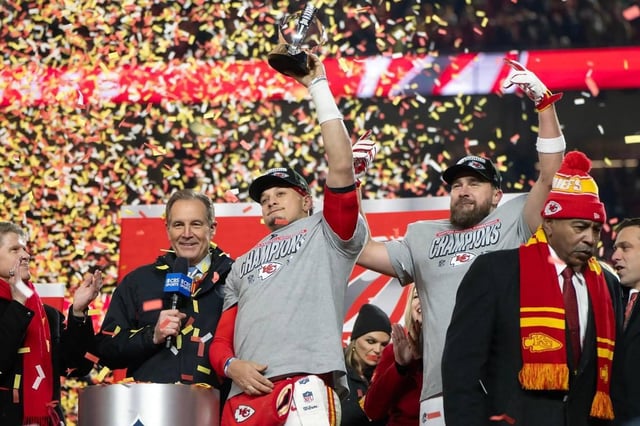 Kansas City Chiefs owner Clark Hunt and broadcaster Jim Nantz look on as Chiefs quarterback Patrick Mahomes hoists the Lamar Hunt Trophy as he celebrates with tight end Travis Kelce after the team’s win over the Buffalo Bills to claim the AFC Championship on Sunday, Jan. 26, 2025, at GEHA Field at Arrowhead Stadium. (Tammy Ljungblad/Kansas City Star/TNS)