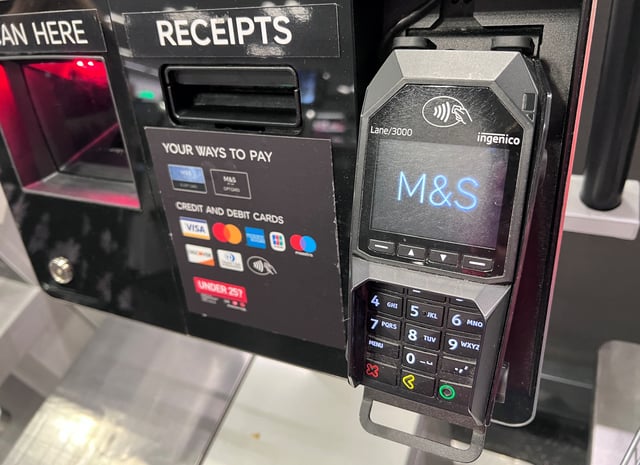A contactless payment card reader is seen at an M&S Food Hall in London, Britain, April 30, 2025. REUTERS/Suzanne Plunkett/File Photo