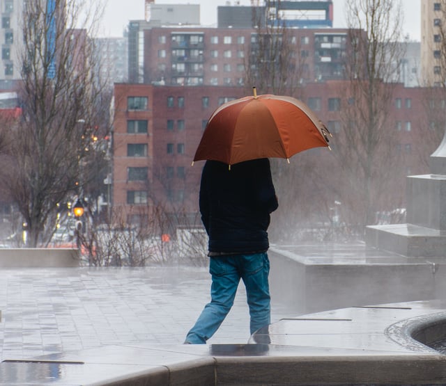Man walking in downtown Montreal on a rainy day, Quebec, Canada