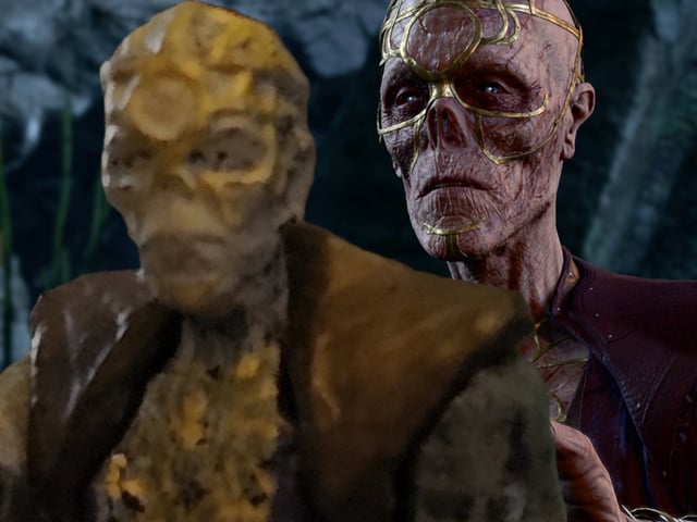 Withers touches the shoulder of his terrible miniature with a mournful expression.