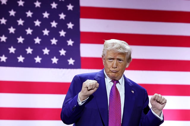 U.S. President Donald J. Trump gestures on stage as he tours the Al Udeid Air Base on May 15, 2025, in Doha, Qatar.
