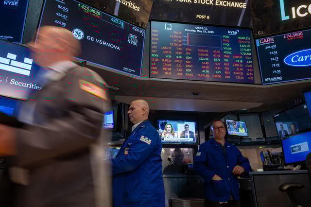 Traders work on the floor of the New York Stock Exchange in New York City on May 19, 2025.