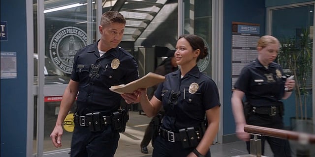 Tim Bradford handing files to Lucy Chen in The Rookie Season 8